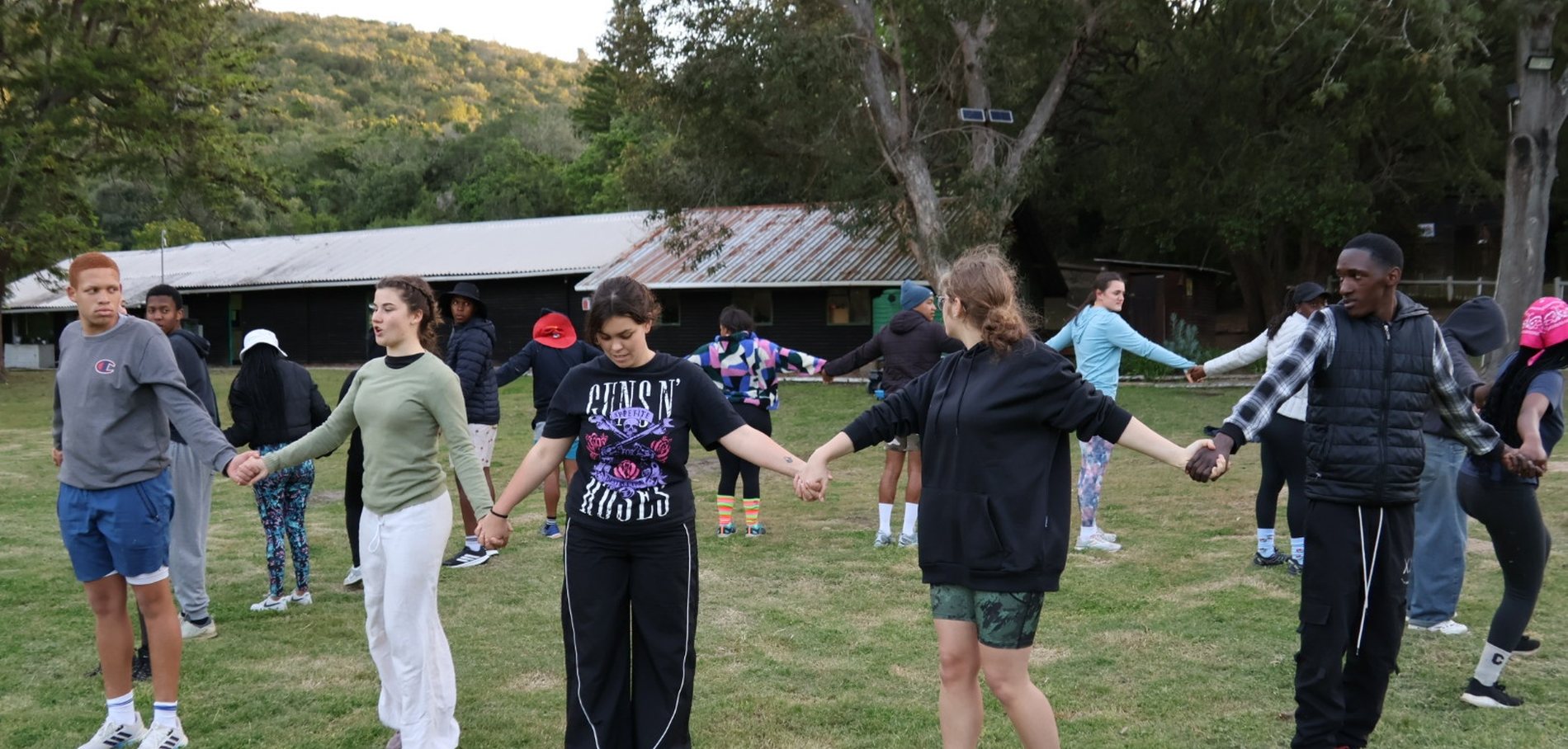School camps - learners in a team circle on the field